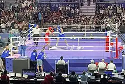 Imane Khelif and Angela Carini are in a boxing ring fighting