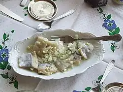 Herring salad with oil and chopped onion as a side dish