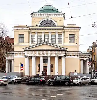 Light yellow building with white columns