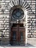 Portal with a window and artistic grille