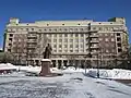 Facade view of the building, with the monument to Kryachkov