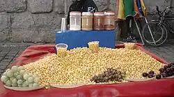 A balila seller sitting behind his goods in a street
