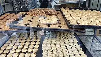 Barazeq (top) seen with other desserts in Syria, pistachio-studded bottom is visible.