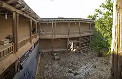 A building with wooden roof and square courtyard