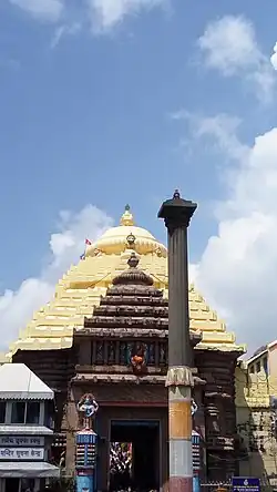 Statue of Aruna, charioteer of Surya, atop the Aruna Stambha in front of the Singhadwara