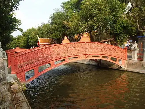 Bridge over the canal beside the marble ubosot.