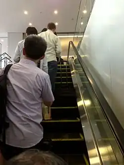 Standing on the left in Japan, where conventions vary between cities.[2]