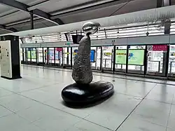 Line 6 platform art installation ("Three Lives on the Stone" - Artist: Weicai Chen)