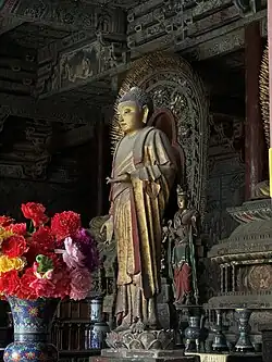 Ming dynasty standing statue of a Buddha with a welcoming stance