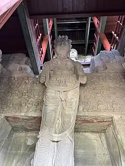 Statue of Shiyimian Guanyin, flanked by the Bodhisattvas Wenshu and Puxian at Tianlongshan Grottoes in Shanxi, China.