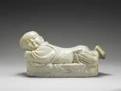 Ding ware pillow in the shape of a recumbent child, Northern Song dynasty (12th century). National Palace Museum.