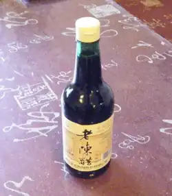 A bottle of dark liquid on a table