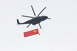 Z-8L carrying the flag flying over Beijing on 1 July 2021 at the 100th anniversary of the Chinese Communist Party.
