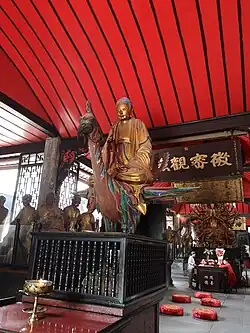 Statue of Amituofo (Amitābha) riding on a peacock at the centre and the Thousand-armed Guanyin at the rear of the Five Hundred Arhat Hall of Baoguang Temple in Chengdu, Sichuan province, China