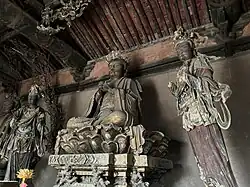 Jin Dynasty (1115–1234) statue of Vairocana with two attendant Bodhisattvas in Longxing Temple in Yuncheng, Shanxi, China.