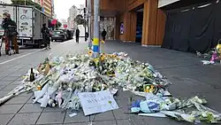 Flowers and messages of condolences in front of Eslite Nanxi