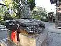 Statue of a red turtle carrying a bell on its back