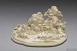 Miniature landscape with figures, Qing dynasty, 18th–19th century. Carved from a single piece of ivory depicting mountains, pavilions, bridges, streams, nine boats, and thirty-four figures. National Palace Museum.