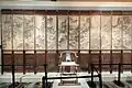 Huanghuali twelve-panel folding screen with chilong, bat, and figural narrative scenes, Ming–Qing dynasty, 17th century.