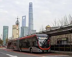 Two buses at a bus stop in Shanghai, China