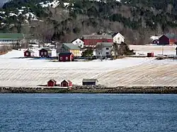 Coastal farm area along the fjord.