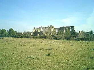 Photo shows a ruined building.