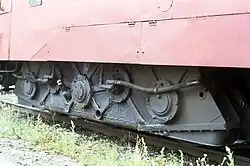 Detail. The final drive is outside the internally mounted wheel sets on one side. Here can be seen the driven side. The gear box is suspended.