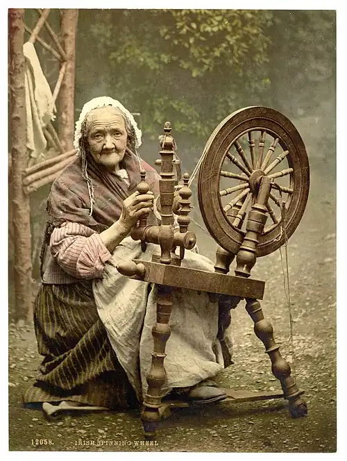A photochrom of an elderly Irish woman using a spinning wheel, County Galway, Ireland, c. 1890s