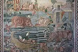 A large mosaic artwork. It is a landscape of a river, with animals and people in the river, including crocodiles and hippos.