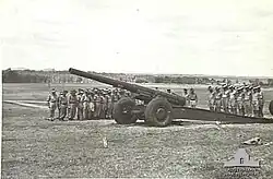 'T' Australian Heavy Battery at Fort Lytton with M1917/1918 155-millimetre (6.1&nbsp;in) heavy gun. Heads are bowed during a ceremony on Armistice Day 1943[gallery 19]