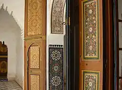 A variety of vernacular decorative Islamic styles in Morocco: wooden panels, zellij tilework, stucco calligraphy, and floral door panels