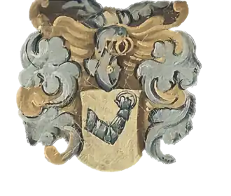 A painted coat of arms featuring an armored arm holding a ring.