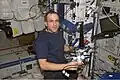 Expedition 8 mission commander and science officer Michael Foale is shown wearing a customized Lower Extremity Monitoring Suit (LEMS) and balancing on the footplate of a special track attached to the Human Research Facility (HRF) rack in the Destiny laboratory to perform a calibration for the Foot Reaction Forces During Spaceflight (Foot) experiment. - NASA Image: ISS08E06860