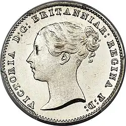 Silver coin with a woman's head facing left