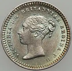 Silver coin with a woman's head facing left