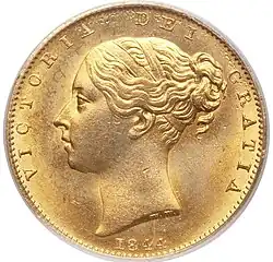 Gold coin with a woman's head facing left