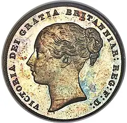Silver coin with a woman's head facing left