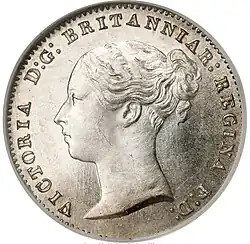 Silver coin with a woman's head facing left