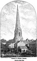 A church, its spire rising far above the few trees and houses around it.