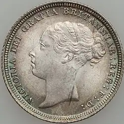 Silver coin with a woman's head facing left