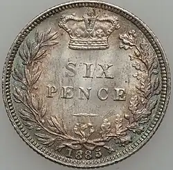Silver coin with its value in a wreath