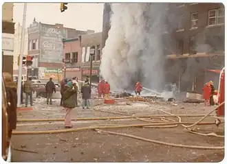 A view of Hotel Pathfinder in the immediate aftermath of the explosion showing a fire crew attempting to put out the subsequent fire