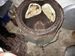 Yemeni modern tannour making Mulawah flatbread