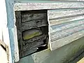 Log structure beneath the siding