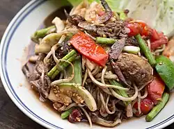 The fruit, of which the seed can easily be seen in this image, can also be used for making green papaya salad in Thailand and Laos