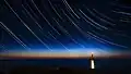 Circumpolar stars in star trails at the La Hague lighthouse, France.