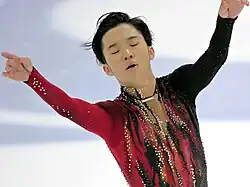Tomono's costume has vertical, painted streaks of red and black accentuated with red, white, and black rhinestones. There is a loop of elastic over his thumbs connected to the sleeves.