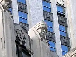 One of the "giants of finance" above the 19th floor. This is a carved head atop a stone pier, looking downward.