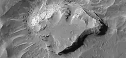 Close-up of one of mesas in previous photo showing layers. Mesa may be the remains of a lake in which sediments were deposited. Taken by HiRISE under the HiWish program.