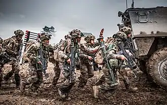 Soldiers of the 35th Infantry Regiment in formation behind a VBCI